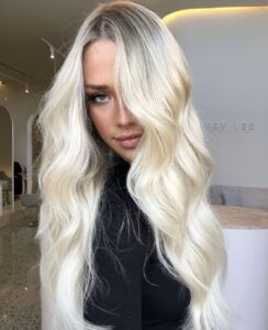 Curly long blonde hair from the front and side, showcasing low maintenance style.
